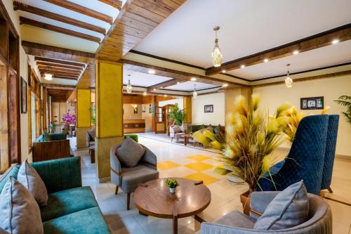 a lobby with couches and chairs and a table at Snow Valley Resorts Dalhousie in Dalhousie