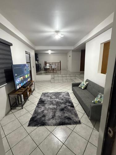 a living room with a couch and a flat screen tv at Casa en segunda planta in Hidalgo del Parral