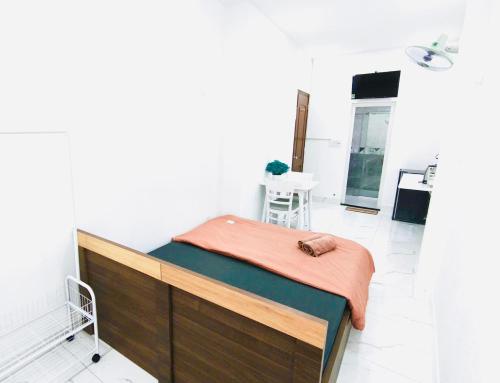 a bed with a blanket on top of it in a room at Kim's House in Ho Chi Minh City