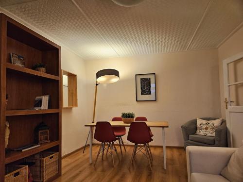 a living room with a dining room table and chairs at Delphi Sunset Apartment in Delfoi