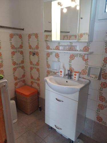 a bathroom with a sink and a mirror at Delphi Sunset Apartment in Delphi