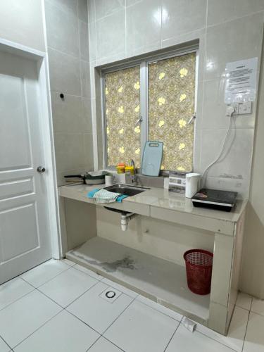 a bathroom with a sink and a window at Ayaan Quintet Evergreen with FIFA & Private Parking in Tanah Rata