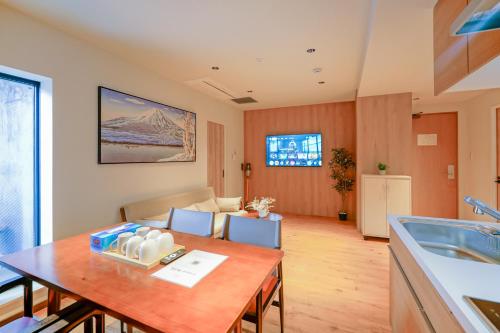 a kitchen and living room with a table and a couch at 中野ワールドホテル in Tokyo