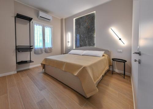 a bedroom with a bed and a wooden floor at Casetta 48 in Lido di Ostia