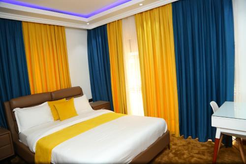 a bedroom with a bed with colorful curtains at SixPoint Victoria in Kisumu