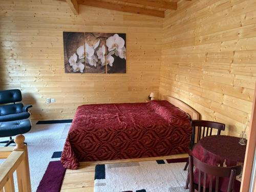 a bedroom with a bed in a wooden room at Beli Bor in Vračar (historical)