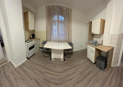 a small kitchen with a white table and a stove at PaNi 2 in Altdorf bei Nuernberg
