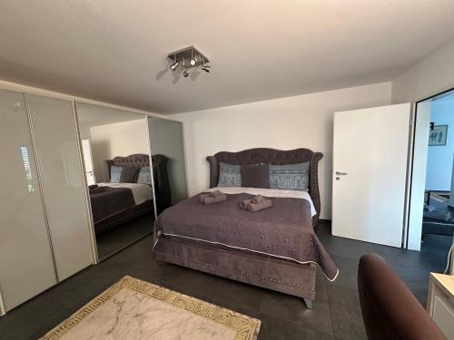 a bedroom with a large bed and a large mirror at V.I.P Appartement in Böttstein