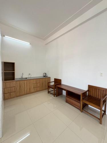 a large room with two benches and a sink at Kim Phung Homestay in Dong Hoi
