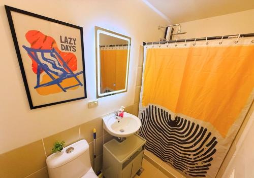 a bathroom with a sink and a toilet and a shower at The Retrograde at The Crestmont in Manila