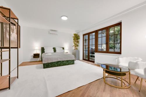 a white bedroom with a bed and a table at Design Apartments Schloss Burg Solingen - BRIGHT Collection in Solingen