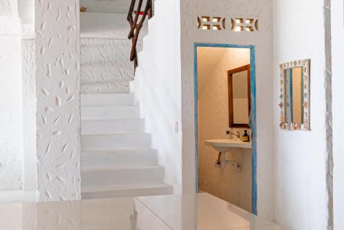 a staircase leading to a bathroom with a sink at Kuruba beach home stays in Rincón
