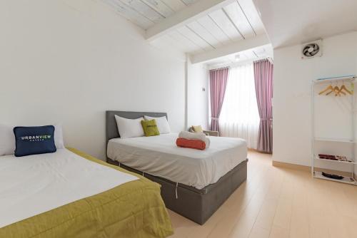Giường trong phòng chung tại Urbanview Hotel Syariah at Rihlah Homestay Batam