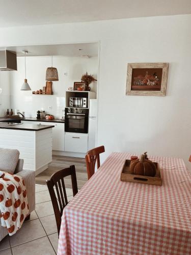 a kitchen with a table with a pumpkin on it at Le gîte de Marceau 