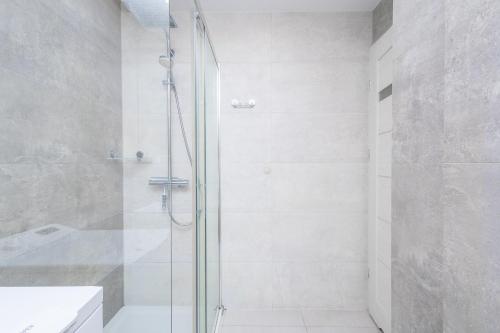 a shower with a glass door in a bathroom at ALABAS - Stylish Central Apartment Check In 24h - Steps from Market Square & River in Wrocław