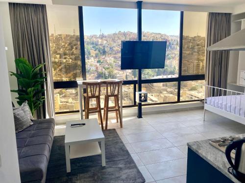 a living room with a couch and a table at Brand new, Modern, Breathtaking view, just for you in Amman