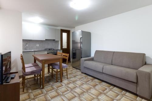a living room with a couch and a table at Sonia Holiday Home - Depandance Kevin in Pont-Saint-Martin