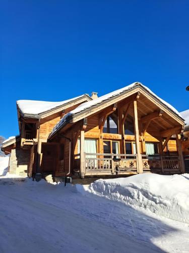 a log cabin with snow on the ground at Casa-Le Cherk Chalet 300m2 jacuzzi sauna Vars in Vars