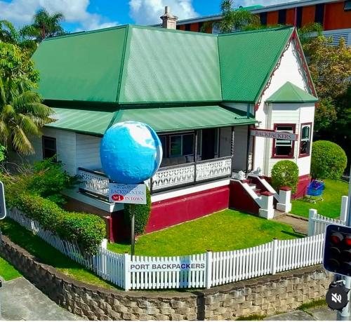 a house with a large blue ball on the front yard at Port Macquarie Backpackers in Port Macquarie