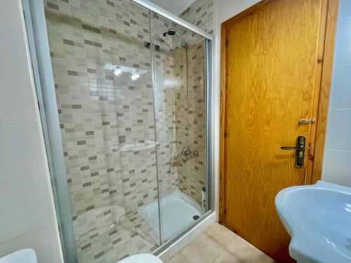 a bathroom with a shower and a toilet and a sink at SA CALETA - Apartamento con piscina y junto a la playa in Cala en Blanes