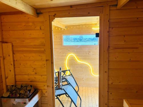an inside view of a wooden cabin with a window at Wohlfühl Oase mit Sauna vor den Toren Berlins in Nauen