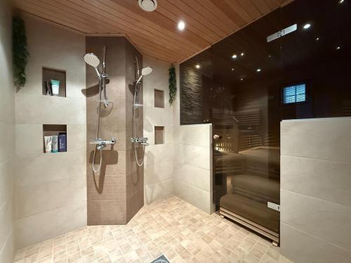 a bathroom with a shower and a walk in shower at Rovaniemi Santas Home in Rovaniemi
