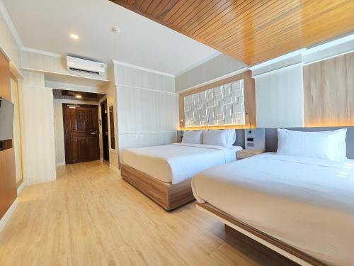 Postel nebo postele na pokoji v ubytování Sira Boutique Chiang Mai