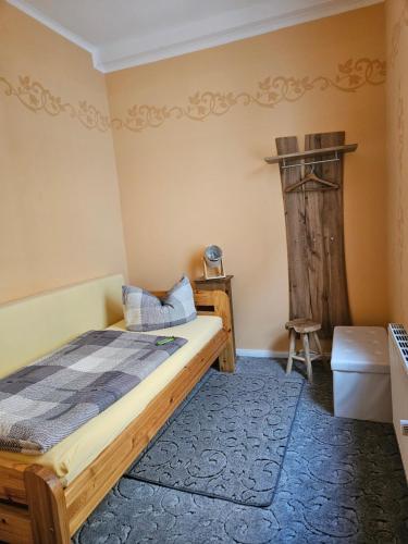 a bedroom with a bed and a chair in a room at Pension am Mönchskirchhof in Stendal
