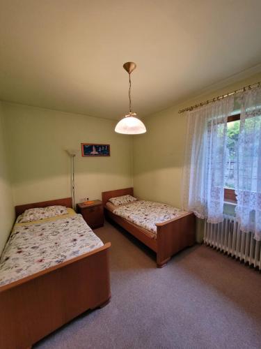 two beds in a room with a window at Villa Viola in Breitenstein