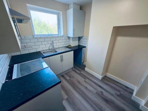 a small kitchen with a sink and a counter top at The Central Hub Luton B in Luton