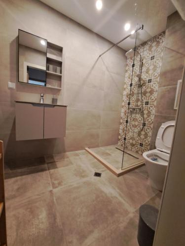 a bathroom with a shower and a toilet at Elegant Stay Apartment in Constantine and Helena, Free Parking in Varna City