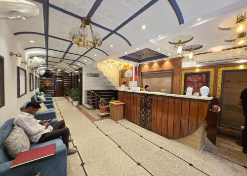 a lobby of a restaurant with people sitting on couches at HOTEL - VISHWANATH ! - ! Varanasi - Providing Air conditioned & Well Decorated Rooms with Free Wi-Fi - & Restaurant With LIft Facilities - Best hotel in Varanasi in Rāmnagar