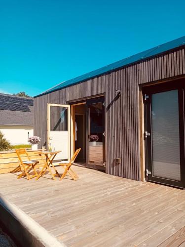 a deck with a table and chairs on a building at XCUBE Tinyhouse in Bad Dürrheim
