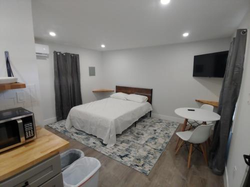 a bedroom with a bed and a table and chairs at Vermont Suites in South Burlington