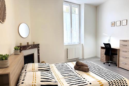 a bedroom with a zebra patterned bed and a desk at Le Baron du Marais - Élégant et central in Roanne