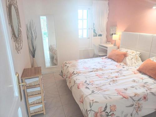 a bedroom with a bed and a mirror at Bright & spacious with aircon in Puerto del Carmen