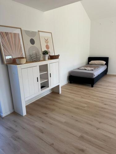 a room with a bed and a table in it at Apartment Lyvia - Platz und Ruhe für 5 in Karsau