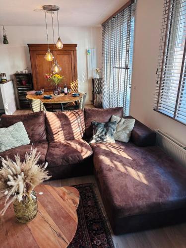 a living room with a couch and a table at Spacious apartment in the heart of the city center with parking space in Breda