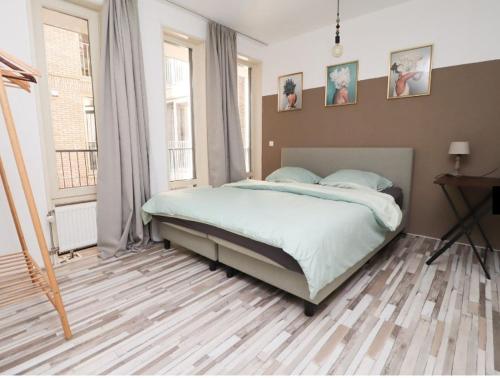 a bedroom with a large bed in a room at Spacious apartment in the heart of the city center with parking space in Breda