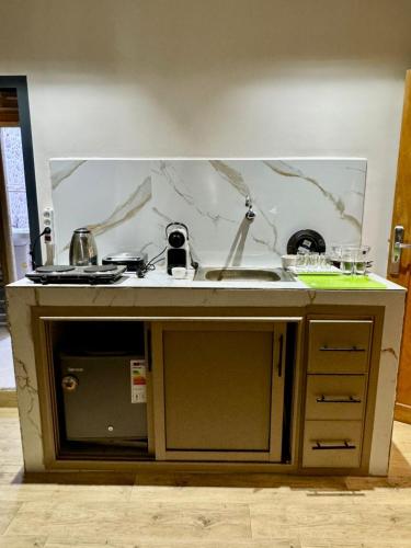 a kitchen with a sink and a counter top at Maison Mira in Rabat
