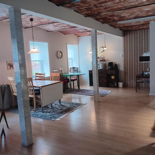 a living room and dining room with a table and chairs at Bøelgaarden in Gørding