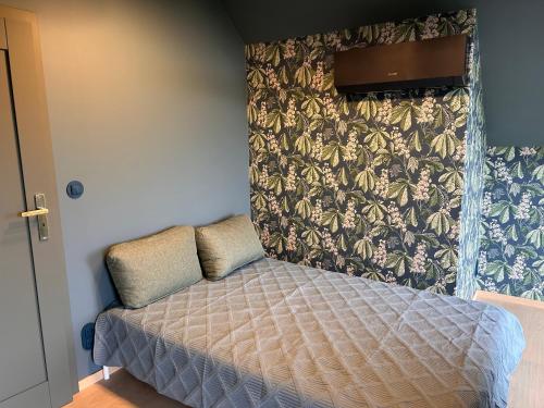a small bed in a bedroom with a wall at Brzozowy Rożnów in Rożnów