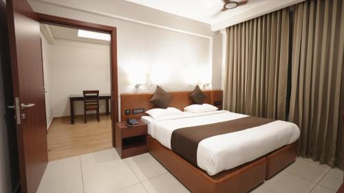 a bedroom with a large bed in a room at AS Suites in Cochin