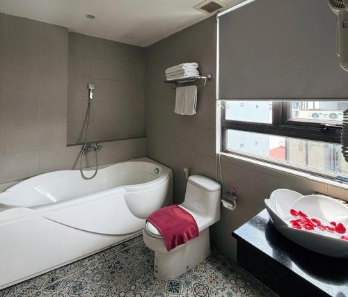 Un baño con bañera, inodoro y lavabo. en Platinum Orchid Hotel Danang, en Da Nang