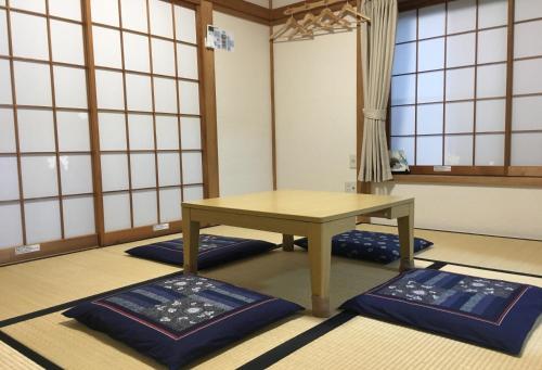 a room with a table and blue mats on the floor at Yokohama - House - Vacation STAY 9002 in Yokohama