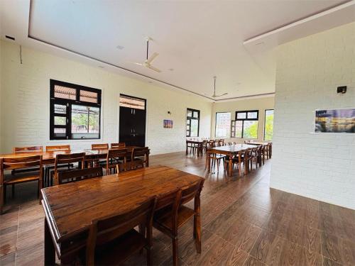 a dining room with wooden tables and chairs at Sajjan Bagh Resort in Pushkar