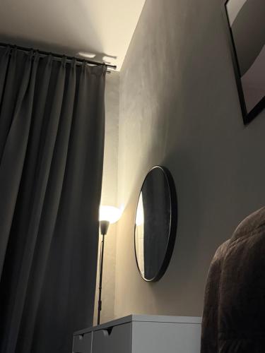 a room with a mirror and a lamp and a window at Mahkota Valley Suite, Lemmie Stay in Kuantan