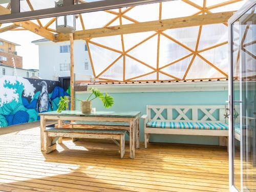 a patio with a bench and a table at Starry Starry Night - Cape Town in Three Anchor Bay in Cape Town