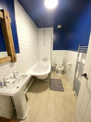 a bathroom with two sinks and a toilet at 7 dodds lane alnwick in Alnwick