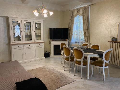 a living room with a dining room table and chairs at Villa Giannina in San Giorgio di Piano